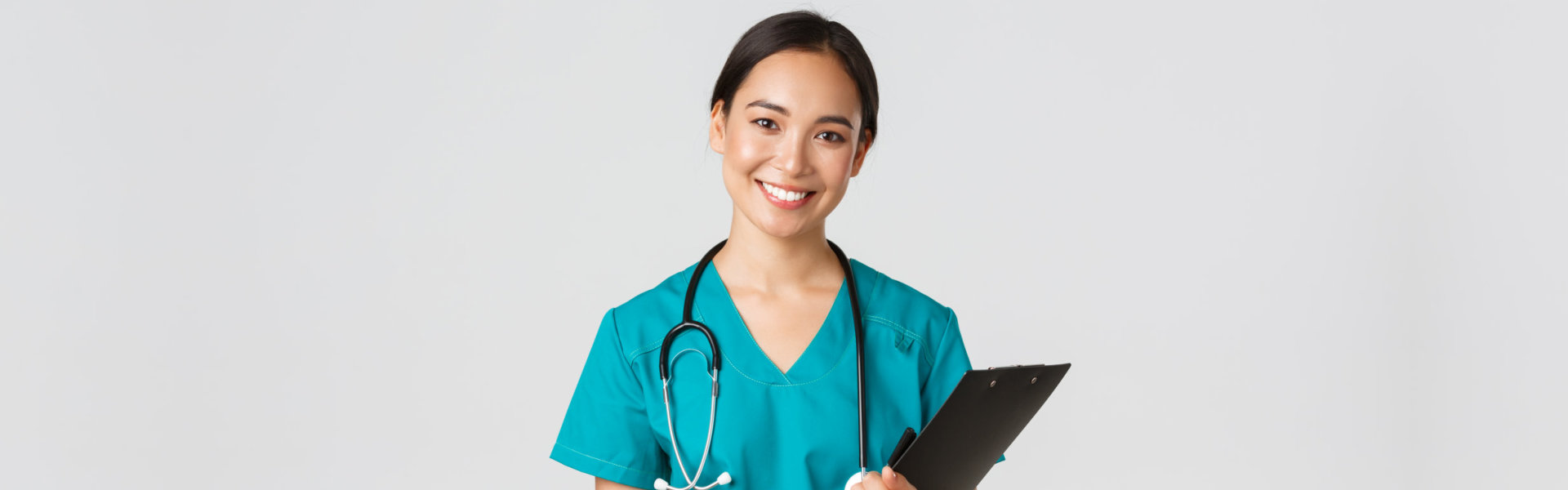 nurse holding folder and smiling