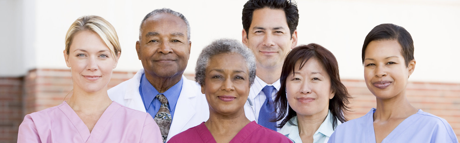 medical staffs smiling and looking at the camera